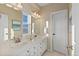 Inviting bathroom with double sinks, bright lighting, and a separate water closet at 6874 Raspberry Run, Littleton, CO 80125