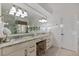 Well-lit bathroom showcasing dual sinks, granite countertop, and a large mirror at 6874 Raspberry Run, Littleton, CO 80125