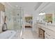 Beautiful bathroom featuring a soaking tub, glass shower, and granite vanity with seating at 6874 Raspberry Run, Littleton, CO 80125