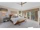 Bright and airy bedroom with a ceiling fan, balcony access, and neutral decor at 6874 Raspberry Run, Littleton, CO 80125