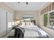 Cozy bedroom with natural light, a queen-sized bed, and ample closet space at 6874 Raspberry Run, Littleton, CO 80125
