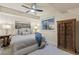 Cozy bedroom featuring a queen bed, nightstands, and a vintage wardrobe at 6874 Raspberry Run, Littleton, CO 80125