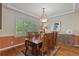 Charming dining room featuring a wooden table with seating for eight and a stylish light fixture at 6874 Raspberry Run, Littleton, CO 80125