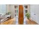 Bright foyer with rich wood floors, a wooden front door with sidelights, and a modern bench at 6874 Raspberry Run, Littleton, CO 80125