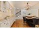 Elegant kitchen with white cabinets, granite countertops, and seamless access to the staircase at 6874 Raspberry Run, Littleton, CO 80125