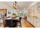 Elegant kitchen with white cabinets, hardwood floors, island seating, and stainless steel appliances at 6874 Raspberry Run, Littleton, CO 80125