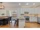 Bright kitchen with white cabinetry, granite countertops, stainless steel appliances, and hardwood floors at 6874 Raspberry Run, Littleton, CO 80125
