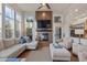 Bright and airy living room with fireplace, plush seating, and large windows for natural light and views at 6874 Raspberry Run, Littleton, CO 80125