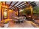 Outdoor dining area with elegant table and chairs under a pergola at 6874 Raspberry Run, Littleton, CO 80125