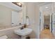 Stylish powder room with decorative tile backsplash, pedestal sink, and modern fixtures at 6874 Raspberry Run, Littleton, CO 80125