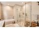 Luxurious bathroom featuring a glass-enclosed shower, soaking tub and neutral tile at 4200 W 17Th Ave # 611, Denver, CO 80204