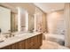 Modern bathroom featuring dual sinks, a sleek vanity, and a separate shower and bathtub at 4200 W 17Th Ave # 611, Denver, CO 80204