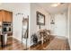 Hallway with wood floors, decor, and access to modern kitchen featuring stainless steel appliances at 4200 W 17Th Ave # 611, Denver, CO 80204