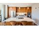 Bright kitchen with wood cabinets, stainless steel appliances, large island with seating, and modern pendant lights at 4200 W 17Th Ave # 611, Denver, CO 80204