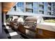 Well-equipped outdoor grilling area featuring multiple stainless steel grills set against a modern building facade at 4200 W 17Th Ave # 611, Denver, CO 80204