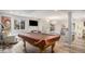 Finished basement featuring a pool table, modern lighting, wood floors and artwork at 22778 E Alamo Ln, Aurora, CO 80015