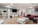 Finished basement featuring wood floors, modern furniture and a television at 22778 E Alamo Ln, Aurora, CO 80015