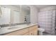 Bright bathroom featuring dual sinks, wood cabinets and a large mirror at 22778 E Alamo Ln, Aurora, CO 80015