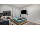 Comfortable bedroom with a bed, desk, and a mounted television at 22778 E Alamo Ln, Aurora, CO 80015