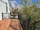 New wood deck with black railing, features a view of the surrounding backyard at 22778 E Alamo Ln, Aurora, CO 80015