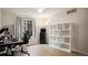 Home office featuring wood floors, a large desk and a modern white bookshelf at 22778 E Alamo Ln, Aurora, CO 80015