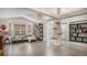 Bright, open-concept living room featuring hardwood floors, neutral paint, and a cat tree at 22778 E Alamo Ln, Aurora, CO 80015