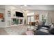 Relaxing living area with a built-in entertainment center, large windows, and hardwood floors at 22778 E Alamo Ln, Aurora, CO 80015