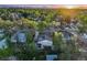 An aerial view of the home in a lush neighborhood with mature trees and mountain views in the distance at 2666 S Green Ct, Denver, CO 80219