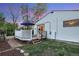 Backyard view showcasing a deck with outdoor furniture, steps down to the yard, and the home's exterior at 2666 S Green Ct, Denver, CO 80219