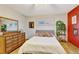 Bright bedroom featuring a comfortable bed, dresser, and natural light, creating a serene and inviting atmosphere at 2666 S Green Ct, Denver, CO 80219