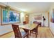 A dining room featuring hardwood floors, light walls, large window, and a wooden table set for six at 2666 S Green Ct, Denver, CO 80219