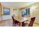 A dining room featuring hardwood floors, light walls, large window, and a wooden table set for six at 2666 S Green Ct, Denver, CO 80219