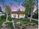 Charming single story home featuring beautiful landscaping with mature trees and flowering plants at 2666 S Green Ct, Denver, CO 80219
