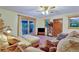 Bright living room with a sliding glass door to a deck, featuring comfortable seating and a warm, inviting atmosphere at 2666 S Green Ct, Denver, CO 80219