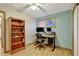 Bright home office with a functional desk setup and a bookshelf, creating a conducive and organized workspace at 2666 S Green Ct, Denver, CO 80219