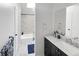 Updated bathroom featuring modern vanity, shower over tub with decorative tile surround, and tile flooring at 3782 S Genoa Cir # A, Aurora, CO 80013