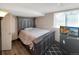 Bedroom with a large bed frame, wood floors, natural light, and decorative carpet at 3782 S Genoa Cir # A, Aurora, CO 80013