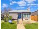 Charming single-story home with a blue front door, concrete steps, and well-maintained front lawn at 3782 S Genoa Cir # A, Aurora, CO 80013