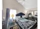 Cozy main bedroom featuring a vaulted ceiling, window, and mirrored sliding closet door at 3782 S Genoa Cir # A, Aurora, CO 80013