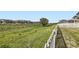 Scenic backyard with a white picket fence, offering privacy and views of the neighborhood at 10555 Boston St, Commerce City, CO 80640