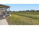 Spacious backyard with lush green grass, a patio area, and a charming white picket fence at 10555 Boston St, Commerce City, CO 80640
