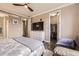 Bright primary bedroom features a TV, ceiling fan, and walk-in closet at 10555 Boston St, Commerce City, CO 80640