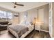 Primary bedroom with large window, contemporary decor, and a ceiling fan at 10555 Boston St, Commerce City, CO 80640