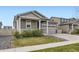 Charming single-Gathering home featuring a two-car garage and well-maintained front yard at 10555 Boston St, Commerce City, CO 80640