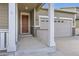 Inviting front porch with elegant columns and a well-maintained two-car garage at 10555 Boston St, Commerce City, CO 80640