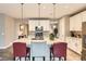 Kitchen with an island, stainless appliances, bar seating, and modern lighting at 10555 Boston St, Commerce City, CO 80640