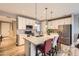 Spacious open-concept kitchen with stainless appliances, kitchen island with seating, and modern finishes at 10555 Boston St, Commerce City, CO 80640