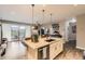 Modern kitchen island featuring stone countertops and views of the living area and patio at 10555 Boston St, Commerce City, CO 80640