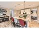 Bright kitchen with a large island, bar seating, modern lighting, and stainless steel appliances at 10555 Boston St, Commerce City, CO 80640