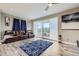 Spacious living room with hardwood floors, a ceiling fan, and sliding doors to a patio at 10555 Boston St, Commerce City, CO 80640